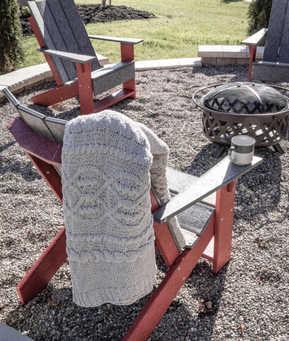 Adirondack chairs by a fire pit