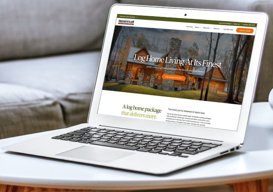 Hochstetler Log Homes website displayed on MacBook Air