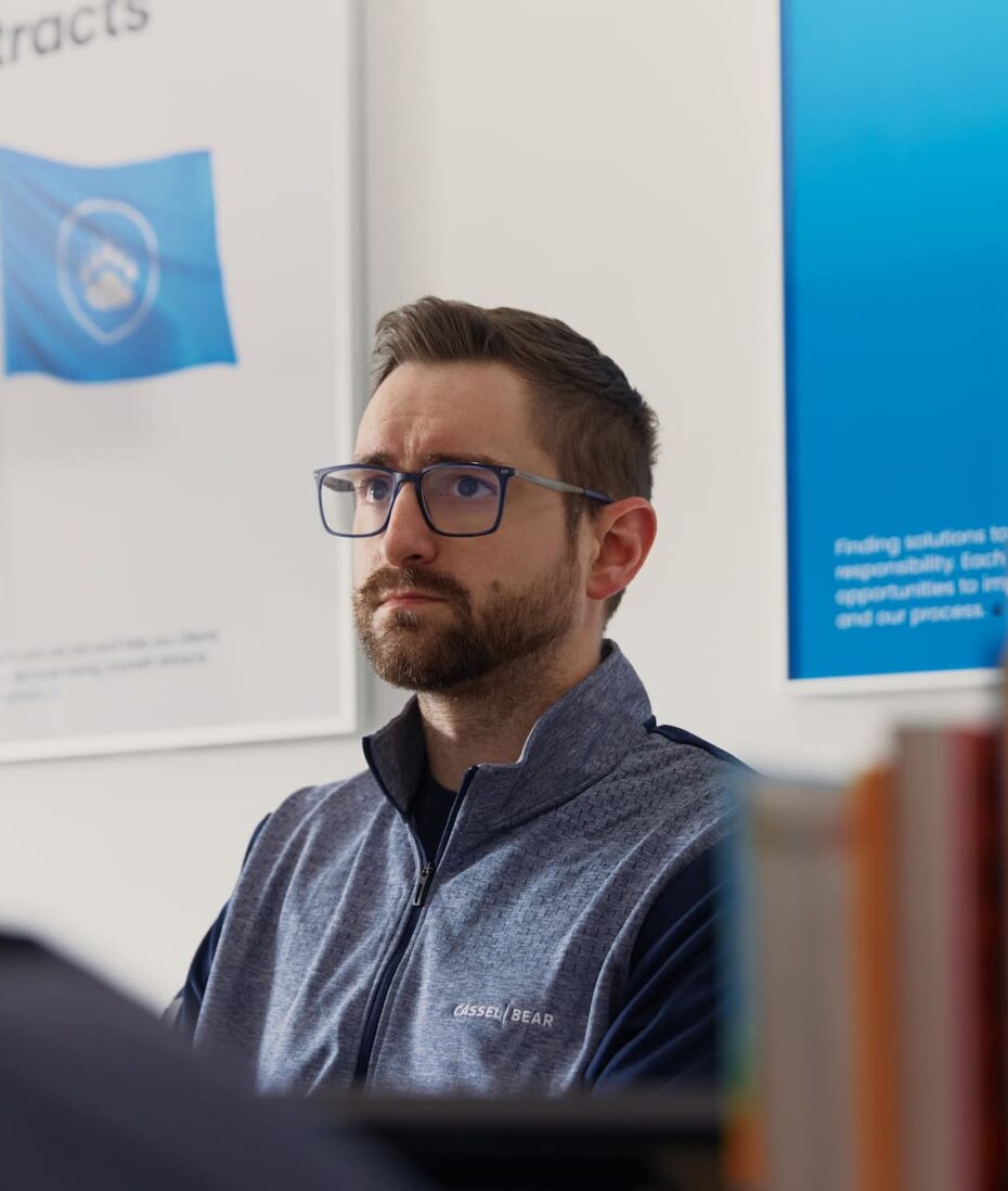 Canton Website Design team member listening during a planning meeting at the Cassel Bear office.