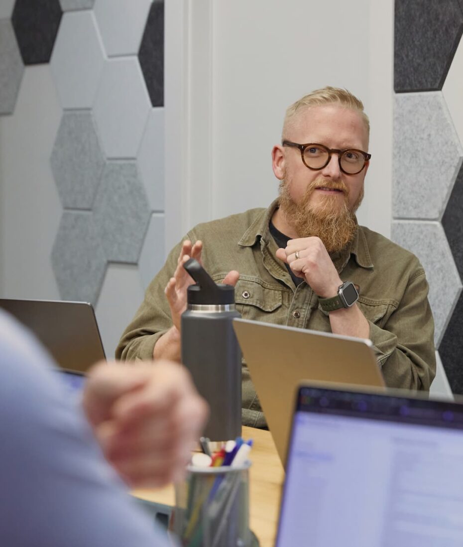 Canton Marketing Agency strategy meeting with a team member presenting ideas at a conference table.