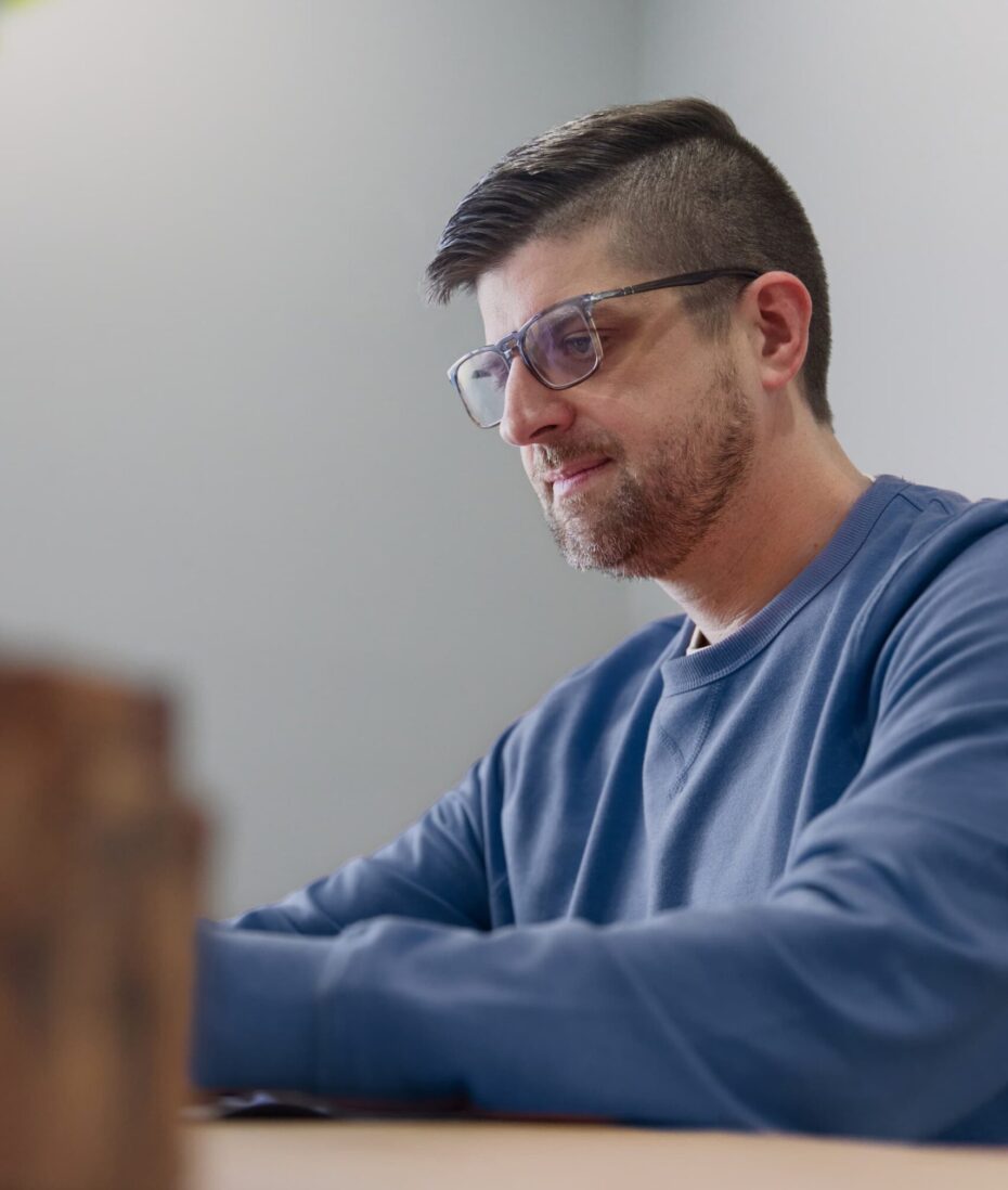 Akron Digital Marketing strategist working at a desk, focused on planning and improving website performance.